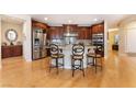 Gourmet kitchen with stainless steel appliances, granite countertops, and a spacious island with bar seating at 7567 Desertscape Ave, Las Vegas, NV 89178