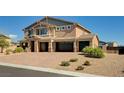 Stunning home featuring a three-car garage and desert landscaping for low-maintenance curb appeal at 7572 Mount Spokane Ct, Las Vegas, NV 89113