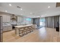 Open-concept kitchen featuring a large center island with seating, modern appliances, and seamless flow to the living area at 7572 Mount Spokane Ct, Las Vegas, NV 89113