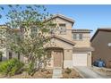 Inviting two-story house with a tile roof, manicured front yard, and an attached garage offering comfortable living at 765 Jewel Tower St, Las Vegas, NV 89178