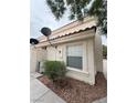 Exterior shot of the townhome, showing the side and some landscaping at 7969 Cina Ave, Las Vegas, NV 89147