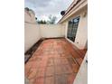 Private outdoor patio with tiled floor and block wall, providing a relaxing retreat at 7969 Cina Ave, Las Vegas, NV 89147