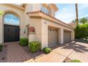 Elegant home featuring a three-car garage and manicured landscaping at 8205 Taos Paseo Ave, Las Vegas, NV 89128