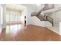 Spacious living area boasts wood floors, a staircase and large windows with shutter shades at 8205 Taos Paseo Ave, Las Vegas, NV 89128