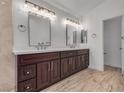 Modern bathroom with dual vanities, bright mirrors, and beautiful marble flooring at 8437 Apple Hill Ct, Las Vegas, NV 89128
