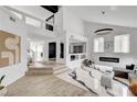 Open-concept living area featuring a modern fireplace and access to upper level at 8713 Castle Ridge Ave, Las Vegas, NV 89129