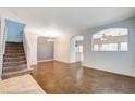 Bright living room with decorative archways, staircase, and tile flooring at 9303 Gilcrease Ave # 1056, Las Vegas, NV 89149