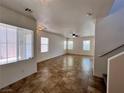 Bright living room with tiled floors, large windows allowing ample natural light and a ceiling fan at 9452 Plover Falls Ave, Las Vegas, NV 89149