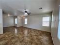 Spacious living room with tile flooring, large windows, and neutral paint, providing a bright atmosphere at 9452 Plover Falls Ave, Las Vegas, NV 89149