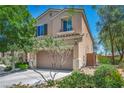 Attractive two-story home with a two-car garage, complimented by mature landscaping and a well-maintained lawn at 10692 Tulip Valley Rd, Las Vegas, NV 89179