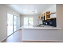 Bright kitchen features stainless steel appliances, modern backsplash, and access to the backyard at 1878 Corvette St, Las Vegas, NV 89142