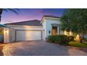 Beautiful home featuring a well-manicured lawn, garage, and a lovely paved driveway at 20 Via Paradiso St, Henderson, NV 89011