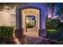 Inviting arched entryway leading to a beautifully landscaped courtyard and home entrance at 20 Via Paradiso St, Henderson, NV 89011