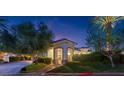 Elegant front entrance with arched portico, lush landscaping, and a charming walkway at 20 Via Paradiso St, Henderson, NV 89011