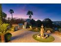 Private backyard patio with built-in barbecue, fountain, and lush landscaping perfect for outdoor entertaining at 20 Via Paradiso St, Henderson, NV 89011