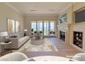 Elegant living room showcasing fireplace, balcony access, and stylish furnishings at 21 Via Visione # 206, Henderson, NV 89011