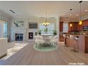 Open-concept living area flows into a well-equipped kitchen with a fireplace and eating area at 21 Via Visione # 206, Henderson, NV 89011