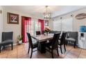 Open dining area with stylish chandelier and seating for six at 2307 Tuscarora Ct, Las Vegas, NV 89142