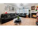 Cozy living room featuring tile floors, a fireplace, and modern furnishings at 2307 Tuscarora Ct, Las Vegas, NV 89142