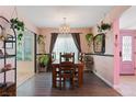 Well lit dining room with chandelier, wood floors, and bright light at 2479 Domingo St, Las Vegas, NV 89121