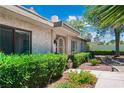 Charming front yard showcasing a lush, well-maintained landscape with mature trees and shrubs at 2479 Domingo St, Las Vegas, NV 89121