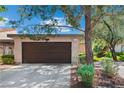 Attached two-car garage with mature trees and professional landscaping at 2479 Domingo St, Las Vegas, NV 89121