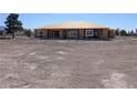 New home under construction with a wooden frame and desert landscaping at 2561 Red Rock Dr, Pahrump, NV 89048