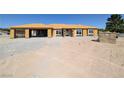 Unfinished home with plywood exterior, large windows, and a spacious three-car garage at 2561 Red Rock Dr, Pahrump, NV 89048