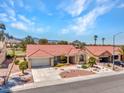 Stunning single-story home with a red tile roof, well-maintained landscaping, and mountain views at 2829 Golf Links Dr, Las Vegas, NV 89134