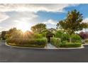 Eye-level shot of the single-story home with a view of lush landscaping at 3004 Astoria Pines Cir, Las Vegas, NV 89107