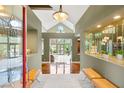 Bright foyer with tile flooring, a bench, decorative displays, and a view of the living room at 3004 Astoria Pines Cir, Las Vegas, NV 89107