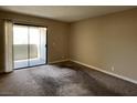 A bright, carpeted bedroom with a sliding glass door leading to an outdoor balcony at 3151 Soaring Gulls Dr # 2147, Las Vegas, NV 89128