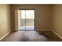 A bright, carpeted bedroom with a sliding glass door leading to an outdoor balcony at 3151 Soaring Gulls Dr # 2147, Las Vegas, NV 89128