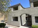 Condominium exterior featuring multi-level patios with an arched entryway and stairwell at 3151 Soaring Gulls Dr # 2147, Las Vegas, NV 89128