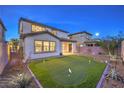 Serene backyard featuring a lush green putting green and thoughtfully designed landscaping at 3213 Molinos Dr, Las Vegas, NV 89141