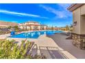 Gorgeous community pool area with comfortable lounge chairs and a relaxing pergola for shade at 3213 Molinos Dr, Las Vegas, NV 89141