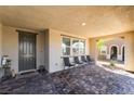 Inviting front porch featuring a brick-paved floor and comfortable seating area for relaxing outdoors at 3221 Pergusa Dr, Henderson, NV 89044