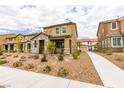 View of charming two-story home with landscaped yard, sidewalk and driveways with surrounding homes at 3270 Palindrome Ave, Henderson, NV 89044