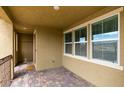 Covered porch with brick pavers, window to the side, railing, and front door to the left at 3270 Palindrome Ave, Henderson, NV 89044