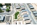 This aerial showcases the property's prime location within a well-planned community with a central green space at 3389 La Cura Ave # Lot 43, Las Vegas, NV 89141