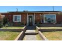 Attractive single-story home adorned with colorful exterior decor and a brick pathway at 4559 S Nellis Blvd, Las Vegas, NV 89121