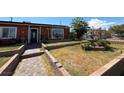 Landscaped front yard featuring decorative stone elements and a charming three-tier fountain at 4559 S Nellis Blvd, Las Vegas, NV 89121