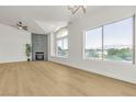 Bright, open living room featuring fireplace, fan, and large windows with outdoor views at 4800 Grey Wolf Ln # 202, Las Vegas, NV 89149