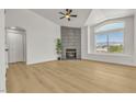 Spacious living room featuring new light wood floors, high ceiling and a modern fireplace at 4800 Grey Wolf Ln # 202, Las Vegas, NV 89149