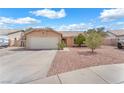 A home with a two-car garage, tile roof, gravel yard, and covered front entry at 503 Credence Ave, Henderson, NV 89002