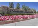 Stone monument sign for Southern Highlands is surrounded by colorful flowers at 5079 Quiet Falls Ct, Las Vegas, NV 89141