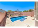 Beautiful in-ground pool in a private backyard setting with a clear blue sky overhead at 5079 Quiet Falls Ct, Las Vegas, NV 89141