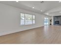 Spacious living room with a large window offering plenty of natural light and modern fireplace at 5079 Reno Ct, Las Vegas, NV 89119