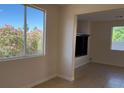 Bright living room with desert landscaping outside the windows, open floor plan and tile flooring at 6024 Ripple Cloud Ct, North Las Vegas, NV 89031