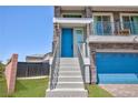Charming two-story home features a blue front door and an inviting balcony with stone accents at 7828 Bright Lodge St, Las Vegas, NV 89139